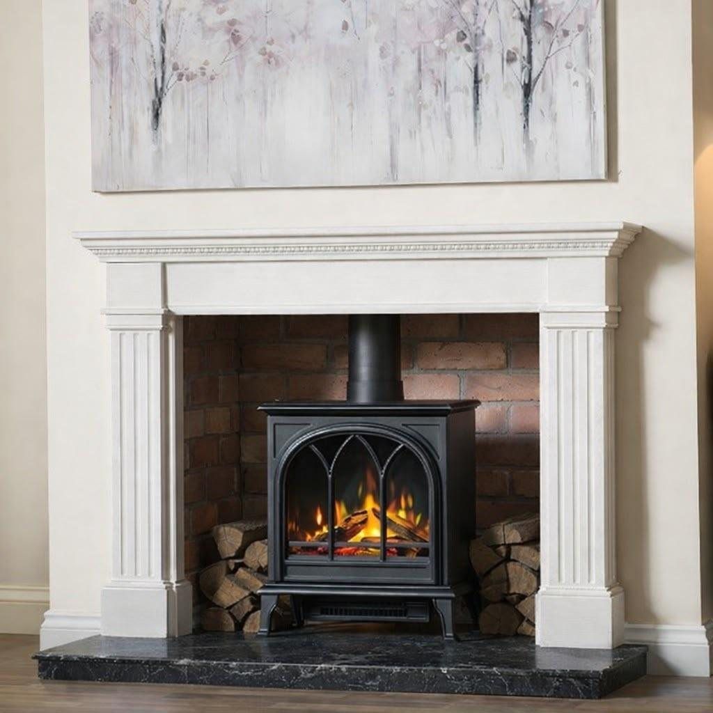 Electric stove with log effect in a white traditional fireplace surround