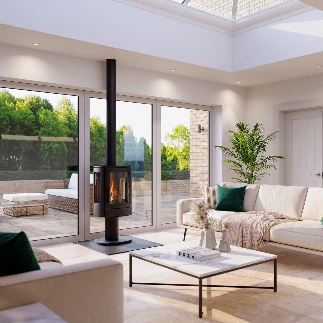 Pedestal wood burner with tall black flue in a light-filled garden room