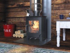 Saltfire Scout wood burning stove lit in a rustic room with timber-clad walls