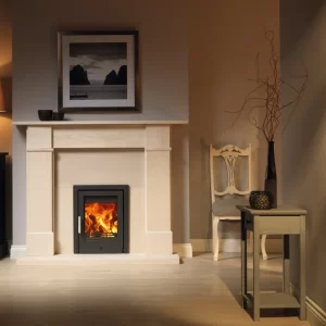 T400 inset wood burning stove lit in a cream stone fire surround
